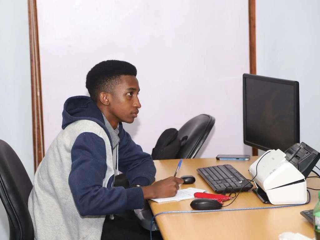 A student taking notes from a computer