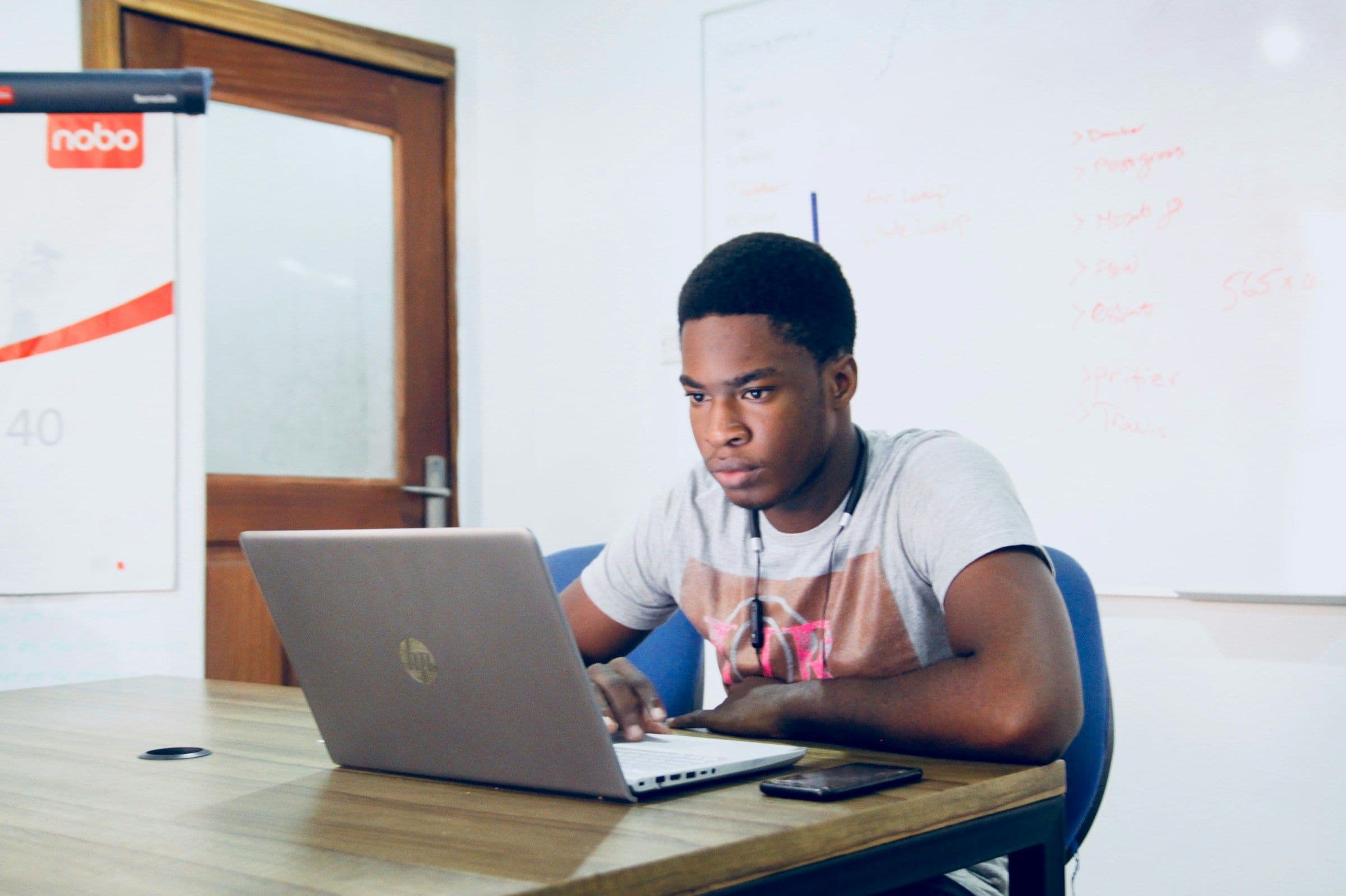 a young man at a laptop working